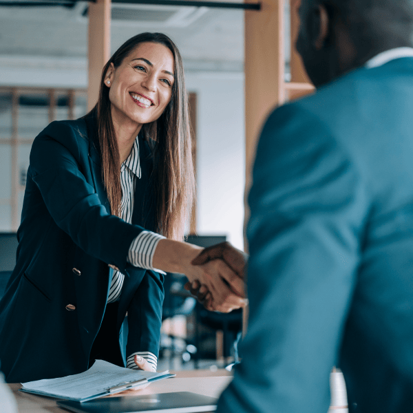 Female manager shaking an employee's hand